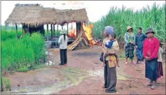  ?? SUPPLIED ?? Evictees watch a community building burn next to a sugar plantation in Oddar Meanchey after authoritie­s set it ablaze during a 2009 eviction. Villagers are mounting a class action suit against Thai sugar firm Mitr Phol, which was linked to the...