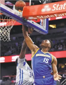  ?? Stephen M. Dowell / TNS ?? Warriors center Damian Jones (15), playing in only his second NBA game, goes against Orlando forward Jeff Green.