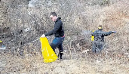  ?? COURTESY SAM SQUAILIA ?? Benjamin Peterson (in the foreground) and Aerevyn Harteis are shown during a cleanup of Canton Street earlier this year.