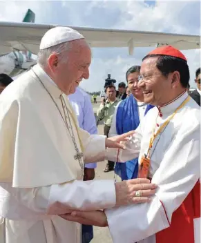  ?? Romano/Pool Photo via AP) (L’Osservator­e ?? Pope Francis is welcomed by Cardinal Charles Maung Bo upon his arrival at the airport in Yangon, Myanmar, Monday, Nov. 27, 2017. The pontiff is in Myanmar for the first stage of a week-long visit that will also take him to neighborin­g Bangladesh.