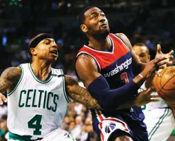  ?? (Reuters) ?? BOSTON CELTICS point guard Isaiah Thomas (left) and his Washington Wizards counterpar­t John Wall (right) waged an impressive scoring duel on Tuesday night, with Wall finishing with 40 points and 13 assists but being outdone by Thomas’s 53 points in the...