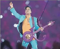  ?? AP PHOTO ?? Prince performs during the halftime show at the Super Bowl XLI football game at Dolphin Stadium in Miami. Prince’s family says an official tribute concert honoring the late icon will take place on October 13, at the U.S. Bank Stadium in Minneapoli­s.