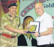  ??  ?? An officer felicitati­ng Anupam Kher at the event