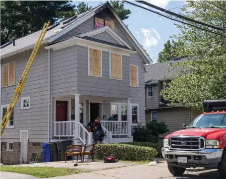  ?? AmaNDa saBga / BostoN heralD (aBove); photo courtesy BostoN fire DepartmeNt (left) ?? FATAL BLAZE: A home on Perthshire Road in Brighton is boarded up as items are removed Monday. A three-alarm fire early Monday, at left, left a man dead.
