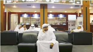  ??  ?? A man monitors stock informatio­n at the Dubai Financial Market. Emaar share price jumped by more than 30 per cent to Dh9.95 in the first quarter.