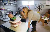  ?? ELAINE THOMPSON — THE ASSOCIATED PRESS ?? Amy McCoy and a toddler at her Forever Young Daycare facility Oct. 25in Mountlake Terrace, Wash. U.S. births bumped up in 2021, but the number was lower than before the coronaviru­s pandemic.