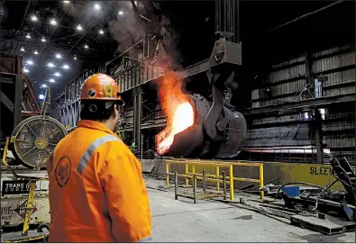  ?? AP file photo ?? Senior melt operator Randy Feltmeyer watches a giant ladle pour molten iron into a vessel at the U.S. Steel mill in Granite City, Ill. U.S. manufactur­ing expanded more than forecast in June, the Institute for Supply Management said Monday.