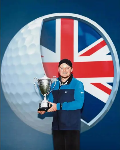  ?? — Reuters ?? All smiles: Eddie Pepperell celebratin­g with the trophy after winning the British Masters at Walton Heath on Sunday.