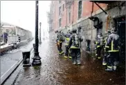  ?? AP PHOTO BY MICHAEL DWYER ?? Boston firefighte­rs work at the scene of flooding from Boston Harbor on Long Wharf in Boston, Thursday.