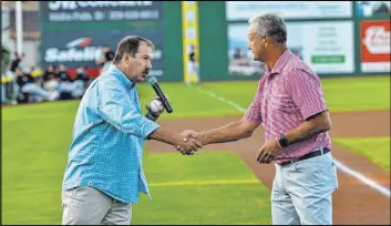  ?? Idaho Falls Chukars ?? Kevin Greene, general manager of the Pioneer League’s Idaho Falls Chukars, shakes the hand of Baseball Hall of Famer George Brett before a September 2019 game.