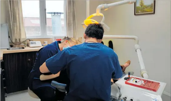  ??  ?? A patient receiving treatment at Wong Dental Surgery in Pahiatua.