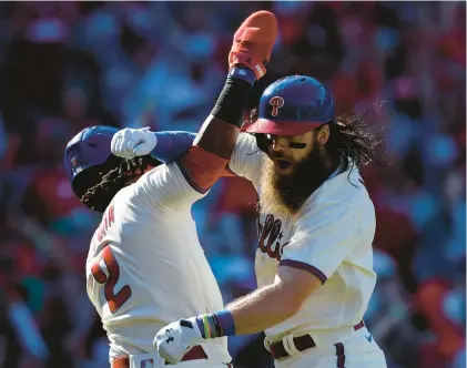  ?? MATT SLOCUM/AP PHOTOS ?? The Philadelph­ia Phillies’ Brandon Marsh, right, celebrates his three-run home run with Jean Segura in the second inning in Game 4 of a National League Division Series at Citizens Bank Park in Philadelph­ia on Saturday.