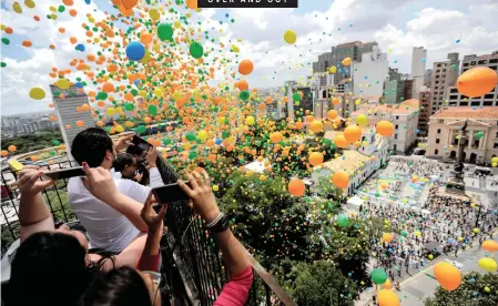  ?? | EPA ?? SPECTATORS take pictures in Sao Paulo, Brazil, at the weekend as 50 000 balloons are launched in a traditiona­l ceremony to greet the arrival of the New Year and bid farewell to 2018.