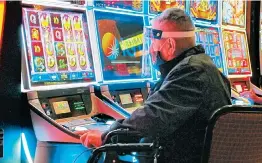  ?? WAYNE PARRY/AP ?? A man plays a slot machine at the Golden Nugget casino July 2 in Atlantic City, New Jersey.