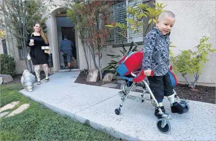  ?? Photograph­s by Mel Melcon Los Angeles Times ?? ERIN OLIVERA watches her son Lucian, who uses a walker because his left leg is paralyzed, perhaps due to a cousin of poliovirus.