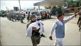  ?? PTI ?? An Afghan security officer carries a baby after gunmen attacked a maternity hospital, in Kabul, Afghanista­n, Tuesday