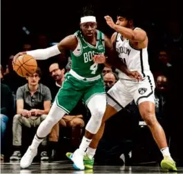  ?? PETER K. AFRIYIE/ASSOCIATED PRESS ?? Celtics guard Jrue Holiday, guarded by the Nets’ Cam Thomas, had 14 points,12 assists, and 5 rebounds.