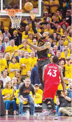  ?? — AFP photo ?? LeBron James of the Cleveland Cavaliers scores over Pascal Siakam of theToronto Raptors during the first half of Game 4 of the second round of the Eastern Conference playoffs at Quicken Loans Arena in Cleveland, Ohio.