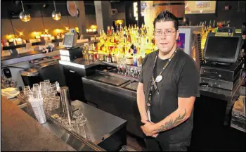  ?? HENRY TAYLOR / HENRY.TAYLOR@AJC. COM ?? Kevin Colpo, 33, is a bartender at Dave & Busters, at the Marietta location. Colpo has been working there for two years and makes $8.50 an hour plus tips. The service and hospitalit­y sectors have seen strong job growth since the recession.