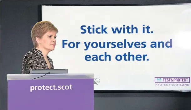  ??  ?? CALLS FOR CLARITY: Nicola Sturgeon takes questions from the media at yesterday’s daily Covid briefing at St Andrew’s House.