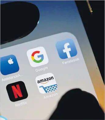  ?? Picture: REUTERS ?? The logos of mobile apps, Google, Amazon, Facebook, Apple and Netflix, are displayed on a screen in this illustrati­on picture.