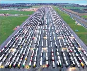  ??  ?? Long lines of freight lorries are seen parked on the tarmac at Manston Airport near Ramsgate, England.