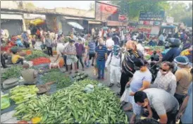  ??  ?? People crowd at a vegetable market after weekend lockdown in Lucknow on Monday.