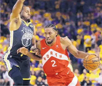  ?? BEN MARGOT/ASSOCIATED PRESS ?? Toronto Raptors forward Kawhi Leonard, seen here against Golden State forward Andre Iguodala, chose to sign with the Clippers, who also acquired Paul George through a trade with Oklahoma City.