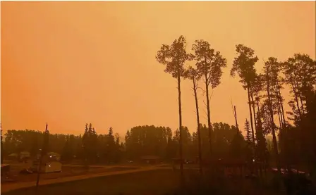  ??  ?? Pallid sky: The Stellat’en First Nation in Fraser Lake, British Columbia, shrouded in an orange haze as smoke continues to drift over from the wildfires. — Reuters