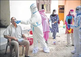  ?? HT FILE ?? A health worker collects swab samples from a man in Gurugram.