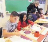  ?? GREG SORBER/JOURNAL ?? Christian Romero begins his painting with his art partner Angelina Abdon. Romero said art is something he looks forward to because he loves drawing.