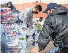  ?? ANNIE RICE/USA TODAY NETWORK ?? Corpus Christi, Texas, firefighte­rs unload water bottles from a pallet last week in Corpus Christi, Texas.