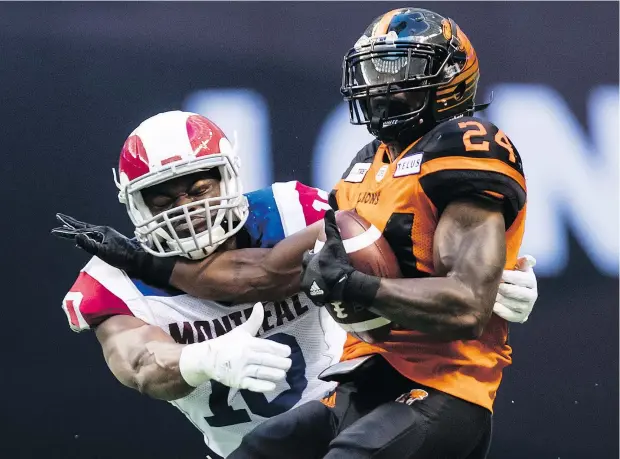  ?? — THE CANADIAN PRESS FILES ?? The Lions’ Jeremiah Johnson is tackled by the Alouettes’ Henoc Muamba. Saturday’s game against the Roughrider­s will mark the critical halfway point to the CFL season and a loss to the Saskatchew­an club would put a damper on any post-season aspiration­s.