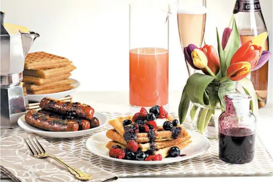  ?? ABEL URIBE/CHICAGO TRIBUNE PHOTOS; SHANNON KINSELLA/FOOD STYLING ?? Waffles topped with fruit and a side of sausages make for a great start to Mother’s Day.