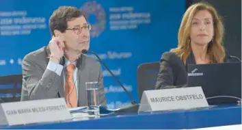  ?? — Reuters ?? Maurice Obstfeld, Economic Counsellor of IMF (L) and Wafa Amr, Communicat­ion Officer of IMF, react during their press conference at the 2018 IMF - World Bank Group Annual Meeting at Nusa Dua in Bali, Indonesia.