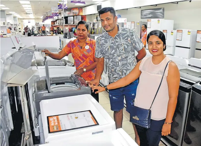  ?? Picture: ELIKI NUKUTABU ?? Courts Customer care officer Sangeeta Nand (left) explains the features of their LG washing machine range to customers Pritnesh Chandra and Vanshika Chand at Courts Rodwell Rd in Suva.