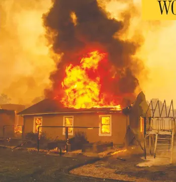  ?? JOSH EDELSON / AFP VIA GETTY IMAGES ?? A home burns at a vineyard near Geyservill­e, Calif., on Thursday. The fast-moving Kincade wildfire engulfed more than 4,000 hectares of land by Thursday and has left nearly 200,000 people in the area without power.