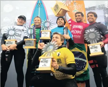  ??  ?? GENERATION NEXT: Reigning WSL Big Wave World Champion Grant ‘Twiggy’ Baker, second left, celebrates on the podium at the Nazare Challenge in Portugal. The event was won by 22-year-old rookie Lucas Chianca. From left are finalists Nathan Florence (6th...