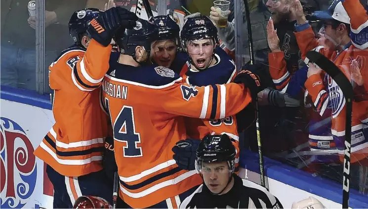  ?? Ed KaisEr ?? Ryan Nugent-Hopkins, right, and the Oilers celebrate his tying goal with 11 seconds left against the Arizona Coyotes on Wednesday night at Rogers Place.