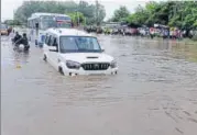  ??  ?? Vehicles wade through a flooded street in Chandigarh on Monday.HT