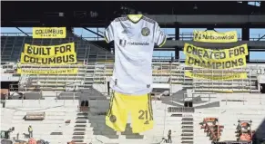  ?? BARBARA J. PERENIC/COLUMBUS DISPATCH ?? Columbus Crew SC unveiled its primary kit for the 2021 season at an event held at the New Crew Stadium on Tuesday. As part of the unveiling of the Crew's new kit, the stadium's integrated tifo-rigging system located in the Nordecke was also be unveiled. The tifo-rigging system will be operated by pulleys and it will be able to display multiple tifos at once, including tifos as large as 300 feet long.