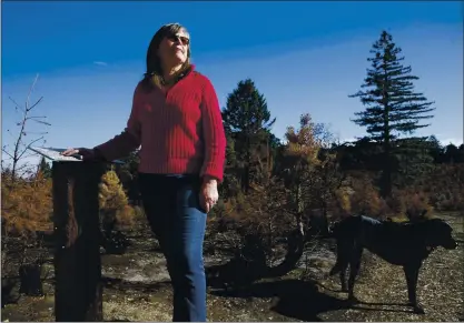  ?? PHOTOS BY JANE TYSKA — STAFF PHOTOGRAPH­ER ?? Co-owner Louise Moran is photograph­ed by burned trees at the Crest Ranch Christmas Tree Farm in Santa Cruz on Wednesday. The farm has been owned by her family for more than 40years and is recovering after the CZU Lightning Complex fire tore through the area in late August.