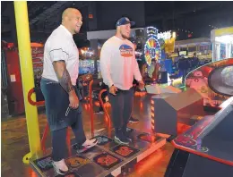  ?? JIM THOMPSON/ JOURNAL ?? Utah State defensive graduate assistant coach Al Lapuaho, left and Aggies’ offensive lineman Jake Templeton show that they’ve got some dance moves while playing a dance game at Main Event Wednesday night.