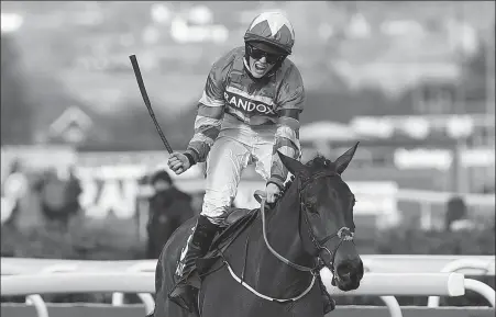  ?? AFP ?? Rachael Blackmore rides Minella Times on her way to winning the Grand National Handicap Chase at Aintree Racecourse in Liverpool, England last Saturday. The race is considered by many to be jumps racing’s toughest test, both for jockey and horse.