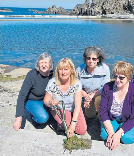  ??  ?? SPRUCE UP: Cleaning out seaweed from the pools are Friends of Tarlair members, from left, Joan Rumens, Pat