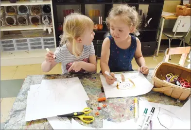  ?? NEWS PHOTO EMMA BENNETT ?? Mackenzie and Paityn work on an art project Thursday at Medicine Hat Community Preschool. A pair of anonymous investors has bought the Riverside building and agreed to a long-term lease for the non-profit preschool after it was nearly forced to find a...