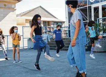  ?? Jessica Christian / San Francisco Chronicle ?? Youth director Bianca Mendoza organizes students for a dance activity with their dance pod in the Mission District of San Francisco, Calif. Being physically active is important for youngsters’ physical health as well as mental health.