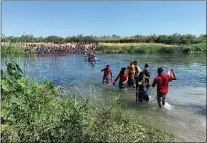  ?? SARAH BLAKE MORGAN — THE ASSOCIATED PRESS ?? Migrants find an alternate place to cross from Mexico to the United States after access to a dam was closed, Sunday, Sept. 19, 2021, in Ciudad Acuña, Mexico. U.S. officials said that within the next few days, they plan to ramp up expulsion flights for some of the thousands of Haitian migrants who have gathered in the Texas city from across the border in Mexico.