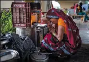  ?? ?? A woman prays Oct. 1 by an overpass where she has taken shelter after evacuating the flooded banks of the Yamuna River.