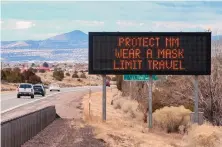  ?? EDDIE MOORE/JOURNAL ?? A sign along Interstate 25 near Santa Fe advises motorists of ways to limit the spread of COVID-19, including Gov. Michelle Lujan Grisham’s executive order requiring that masks be worn in public.